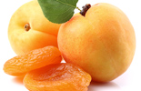 fresh apricots, dried apricots and an apricot leaf