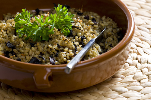 barley and mushrooms casserole garnished with parsley