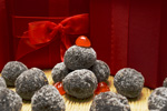 twelve chocolate bourbon balls and a big red bow