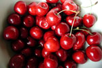 dark red and light red cherries, some with stems