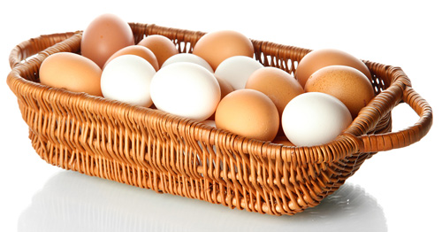 brown and white eggs in a basket