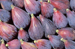 raw unpeeled figs in a pile