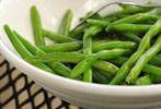 sauteed green beans in a white bowl