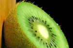 half an unpeeled raw kiwi fruit with blakc seeds