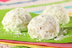 three mexican wedding cake cookies on a green mat