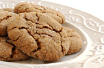 six sugar topped molasses  ginger cookies on a plate