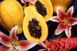 two whole papayas, two half papayas and three flowers