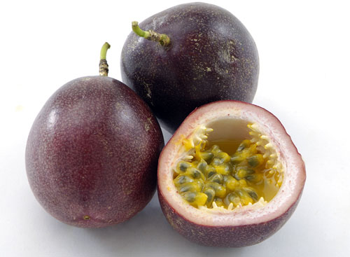 two whole unpeeled passion fruits and one half passion fruit