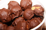 chocolate covered peanut butter balls in a white bowl