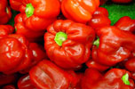 pile of shiny raw red bell peppers