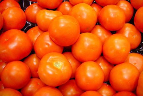 pile of bright whole red fresh tomatoes