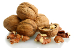 four whole walnuts, one half walnut and shelled walnut pieces