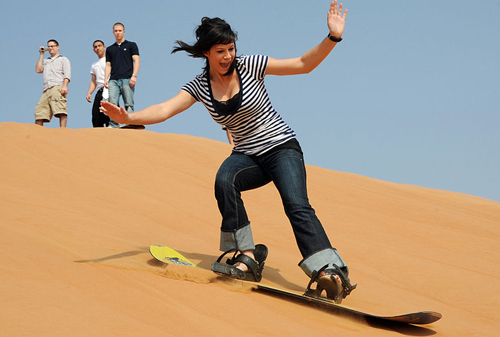 female sandboarder sandboarding downhill