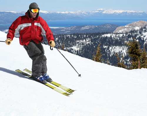 skiier in a red jacket skiing downhill